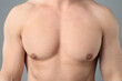 © New Africa - Young man with smooth chest after epilation procedure on light grey background, closeup