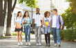 © Prostock-studio - Happy university students walking together on campus, chatting and laughing outdoors during break, copy space