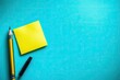 © oldcreativestd - A vibrant turquoise background holds a yellow sticky note and writing utensils