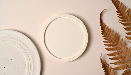 Poster - Artistic display of minimalist white plates and dried fern leaves studio setting photography calm environment top-down perspective aesthetic concept