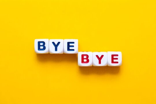 Bye Bye Text on Block Letter Tiles on Yellow Orange Background.