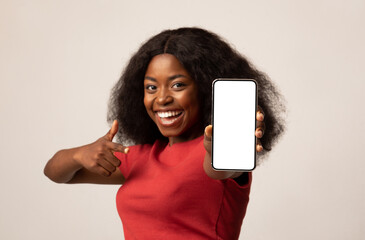 Aufkleber - Cheerful Black Woman Pointing On Smartphone With Blank White Screen In Her Hand, Happy African American Female Demonstrating Cellphone With Copy Space For Mobile App Or Advertisement, Mockup Image