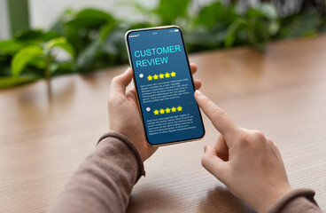 Aufkleber - Consumer Showing cell phone with five star for Satisfaction rating on blue screen, blurred background. Customer Experience Concept