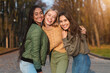 © Prostock-studio - Three pretty multiethnic teen girls posing in public park