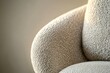 © jayantha - Close-up of a beige textured armchair, showcasing its soft fabric and curved design.