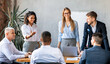 © Prostock-studio - Corporate Meeting Concept. Colleagues Presenting And Brainstorming Business Idea In Modern Office. Selective Focus