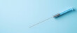 © artzone - Light Blue Syringe With Droplet Line On Light Blue Background
