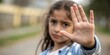 © Bounpaseuth - Girl Child Stop Hand Gesture Protection - Child safety and well-being