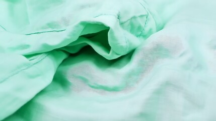 Poster - Gentle folds of a soft, flowing mint green fabric create an abstract design