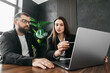 © wedmoments.stock - Two business team leaders man and woman working in the office at a corporate meeting at a laptop in the lobby of a modern office. Business concept.