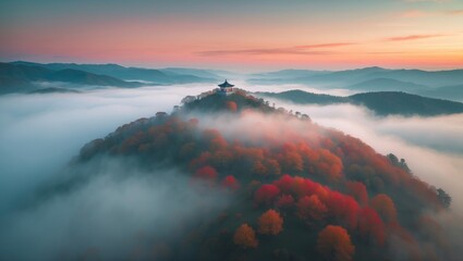 Wall Mural - drone perspective of hilltops with vibrant red and orange trees amid foggy autumn sky