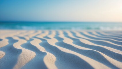 Wall Mural - Uneven sandy shore featuring a hazy blue sea and sky backdrop