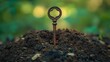 © Pinkwhite - An old key is stuck in a pile of rich, dark soil outdoors. It can represent unlocking potential, growth, or discovering something new.