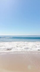 Poster - Soft waves gently roll onto the sandy shore, creating a serene and peaceful atmosphere under a clear blue sky, inviting viewers to experience the tranquility of nature's embrace