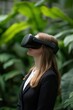 © Aleksey - Woman Using VR Headset in Lush Green Background for Immersive Experience.