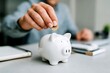 © Graini - Saving Money Wisely Person Putting Coin in Piggy Bank Financial Planning Budget Investment