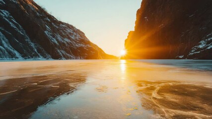 Poster - Frozen lake reflecting the warm light of the setting sun, creating a beautiful contrast with the cold, snow covered rocky cliffs on each side