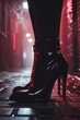 © Rafal Woo - Black patent leather boots with red reflections in dark urban alley at night