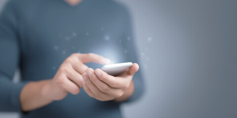 Poster - Individual using smartphone with glowing interface, showcasing modern technology and interaction, emphasizing digital communication and innovation in a contemporary setting