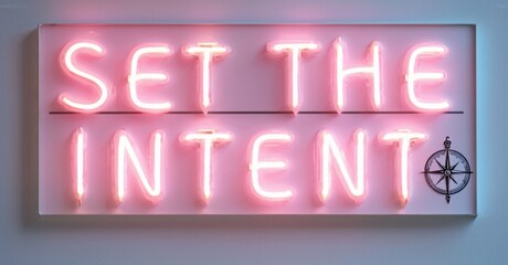 Poster - Pink neon sign displays text Set Intent. Compass symbol present. Minimalist aesthetic, dark background, simple design.