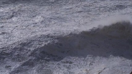 Wall Mural - powerful ocean waves building and crashing against rocky portuguese coastline, generating massive wh