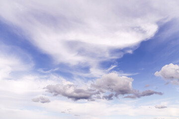 Wall Mural - Beautiful light blue sky with many white cirrus and fluffy clouds in sunlight, background texture, heaven