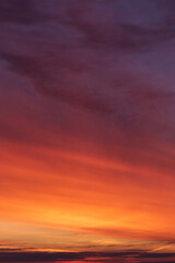 Wall Mural - Dramatic soft sunrise, sunset red violet orange sky with clouds and yellow sunlight abstract background texture