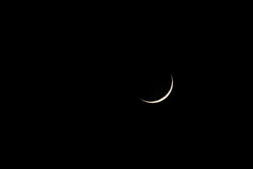 moon against a black night sky. a minimalist astronomical image, ideal for themes of silence, space,