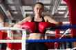© New Africa - Woman with protective gloves on boxing ring