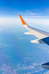 aerial view from airplane window above green ground. view from the airplane window with beautiful cl
