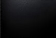 © Pushkarita - a black leather texture, dark natural decorative background with light for any purposes