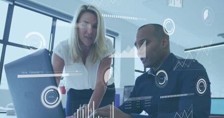 Poster - Female colleague leaning over desk, male colleague typing on laptop with business analytics charts