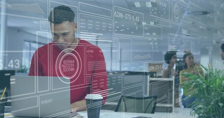 Poster - male data analyst typing on laptop in open-plan office, displaying floating holographic data panels