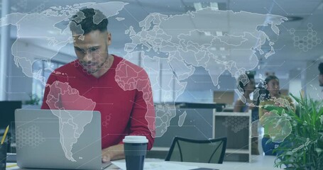 Poster - Man in red sweater working on laptop in corporate office, with transparent world map overlay