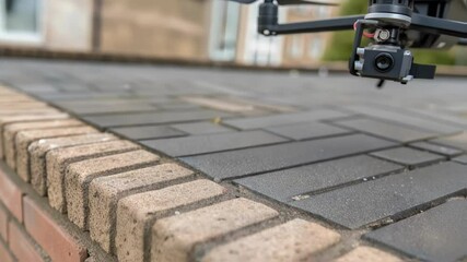 Poster - A closeup of the drones specialized gripper mechanism gripping a textured brick with a focus on the precisionengineered components that ensure a secure hold.