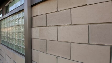 Poster - A medium closeup of glass blocks embedded in a wall designed with layered membranes that allow air flow for carbon capture featuring a sleek and modern appearance that enhances