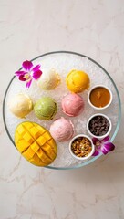 Poster - A round tray filled with various colorful desserts, including mango slices, macarons, and chocolate pudding. The desserts are garnished with flowers and served on ice.