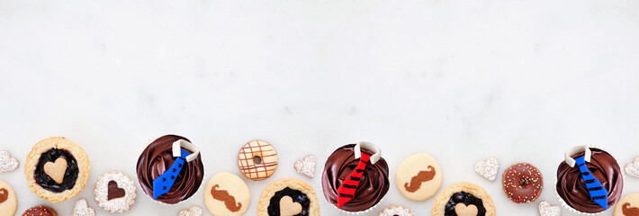 Leinwandbilder - fathers day themed baking bottom border with assorted cookies and sweet treats. top down view on a w