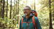 © Postmodern Studio - Mature caucasian male hiking in forest with backpack on sunny day
