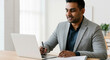 © Postmodern Studio - South asian adult male professional using laptop for business meeting