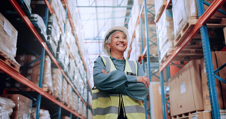 Poster - Warehouse, confidence and woman in logistics inventory with boxes, arms crossed and stock management. Low angle, smile and mature worker in cargo storage, global export and supply chain distribution