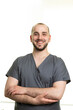© Viktoriia - Smiling Male Medical Professional in Scrubs Posing with Confident Posture and Friendly Expression in Bright, Minimalist Environment