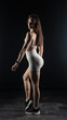 © vadim_fl - Young beautiful woman with athletic body on dark background. Fitness girl