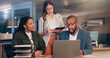 © peopleimages.com - Night, business people or laptop in office for meeting, planning or explain new software. Finance team, tech or discussion in agency for budget review, company compliance or advice for audit deadline