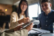 © Miljan Živković - japanese woman entrepreneur paying bill contactless with debit card