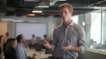 Poster - Young Professional Giving Presentation in Modern Office Space with Engaged Audience Listening Intently During Business Meeting 4k video footage