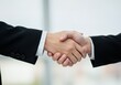 © stock.metket.com - Close-up of a handshake between two business people dressed in suits against a bright, neutral background