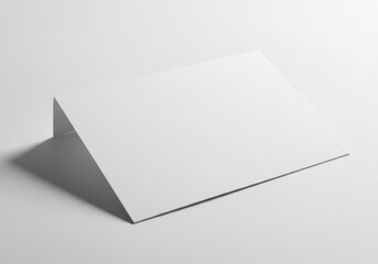 Poster - Abstract white paper folded in a triangle shape casting a shadow on a white background