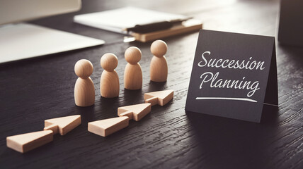 Poster - Wooden figures with arrows symbolize succession planning, a concept for business strategy and future leadership, showcased on a dark desk with a sign indicating 