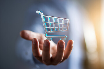 Poster - Hand holding a transparent shopping cart icon, showcasing online shopping and e-commerce concepts